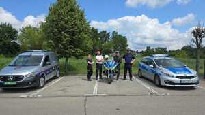 policjanci i strażnicy miejscy pomiędzy radiowozami.