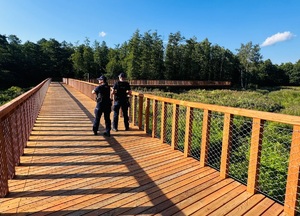 Policjanci patrolują ścieżkę na Pustyni Błędowskiej.